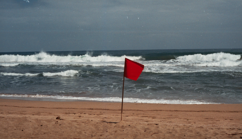 Red flag on a beach as a warning sign