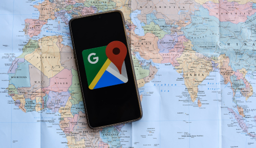 Google Maps on a phone laying on a world map