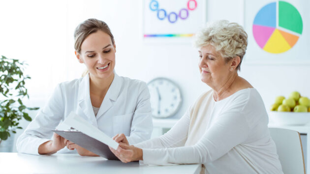 Nutritionist showing a personalised weight-loss diet plan to a patient